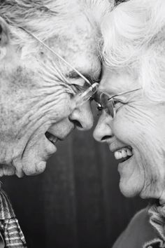 an older couple laughing together in black and white