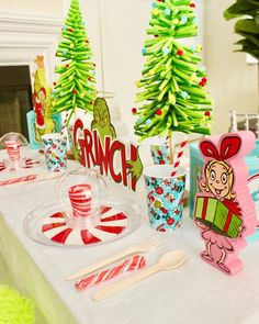 the table is set up with candy canes and paper decorations for grinch's christmas party