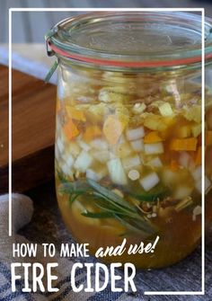 a glass jar filled with food sitting on top of a table next to a cutting board