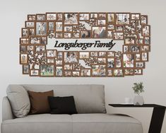 a living room with a couch, coffee table and large family pictures on the wall