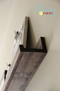 a wooden shelf mounted to the side of a wall