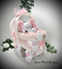 a stuffed elephant in a pink baby carriage