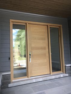 two wooden doors on the outside of a house