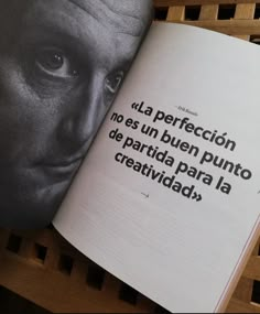 an open book with words written in spanish on the pages and a photo of a man's face