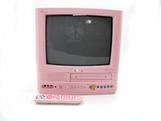 an old pink tv and remote control on a white background