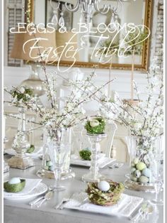 an easter table with eggs and flowers in vases