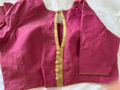 This Magenta, Gold Brocade silk Blouse will make a delightful addition to your collection. It comes with piping all over and an open front. Product : Blouse Material : Brocade silk Size fits 36/42 ( Margins Included) Colour : Magenta, Gold Sleeve length :  10.5 inches Back Neck : Keyhole Front Neck : 6.5 inches - 'U' Neck Padding : Yes Lining : Yes.  Blouses are designed in-house from SumasEthnicWear  Care : Hand wash separately | line dry in shade | warm Iron Note: Minor colour differences poss Crop Top Lehenga, Brocade Blouse, Brocade Blouses, Gold Brocade, Saree Blouses, Black Saree, Bollywood Style, Silk Brocade, Gold Silk