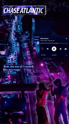 two people standing in the middle of a city at night with neon lights on them