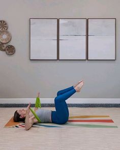 a woman is laying on the floor doing yoga