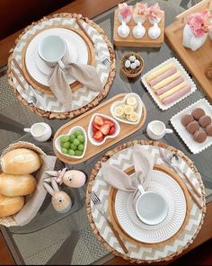 the table is set with plates, bowls and other items for an easter brunch