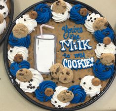 two cakes decorated with cookies and frosting on top of each other in the shape of a milkshake