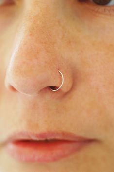 a woman with a nose piercing on her nose