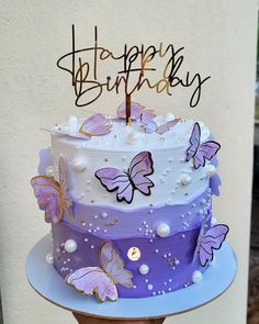 a birthday cake with purple butterflies on it