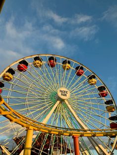 an amusement park ferris wheel on a sunny day