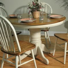 a white table with four chairs around it