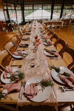 a long table is set with plates and place settings