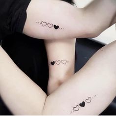 two women with matching tattoos on their legs