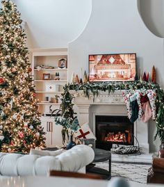 a living room with a christmas tree and fireplace