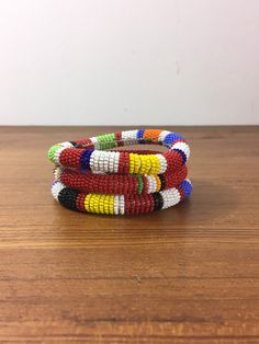 "Here is a set of three (3) gorgeous bangle bracelets from the Maasai tribe in Kenya. Black seed beads are accented with gold geometric pattern and colorful stripes. Bracelets measures approx. 2-1/2\" inside diameter. A wonderful gift to give to that someone special or to keep for yourself! NOTES: ~I make every attempt to list and picture any flaws within all of my item descriptions, such as any prominent chips, cracks, stains, discoloration or missing elements. Please refer to pictures, as they African Beaded Bracelets, Gold Geometric Pattern, Hand Beaded Necklace, Beaded Bangles Bracelets, Native American Necklace, Glass Bead Bracelet, Bead Bangles, Black Seed, Maasai