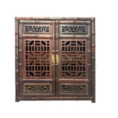 an old wooden cabinet with intricate carvings on the front and side doors, isolated against a white background