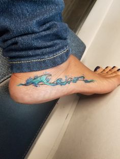 a person with a tattoo on their foot