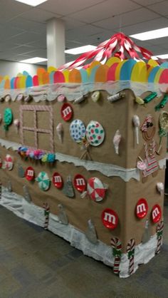 an office cubicle decorated like a gingerbread house with candy and candies all over it