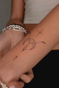 a woman's arm with a small tattoo on the left side of her arm