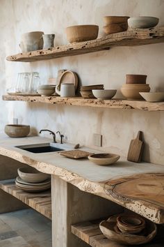 wooden shelves with bowls and plates on them in a rustic style kitchen, along with other dishes