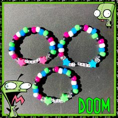 three bracelets with different designs on them and the words doom written in green