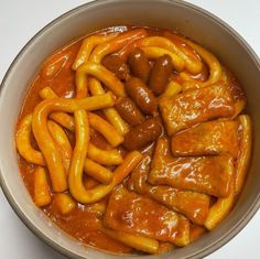 a bowl filled with lots of food on top of a table