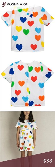 🆕 Mini Rodini Rainbow Love Woven Top Off white blouse in 100% organic woven cotton with all over rainbow love. The blouse has short sleeves, rounded collar, bow at neckline and snaps down the back. Coordinating skirt available. EUR sizing Mini Rodini Shirts & Tops Tees - Short Sleeve Cute Multicolor Cotton Blouse, Summer White Blouse With Heart Print, White Heart Print Blouse For Summer, White Casual Blouse With Heart Print, Summer Cotton Top With Heart Print, Fun Red Tops For Playwear, Fun Red Top For Playwear, Multicolor Graphic Print Tops For Playwear, Cute Heart Print Summer Tops