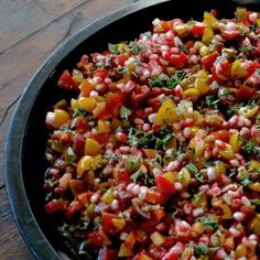 a pan filled with chopped vegetables on top of a wooden table