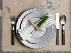 a place setting with silverware and napkins