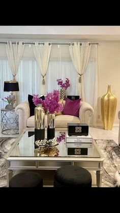 a living room filled with lots of furniture and flowers on top of a coffee table