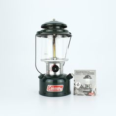 the camping lantern is on display next to its box and instruction manual for how to use it