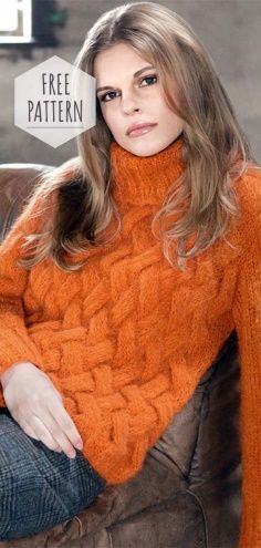 a woman in an orange sweater sitting on a brown leather chair with her arms crossed