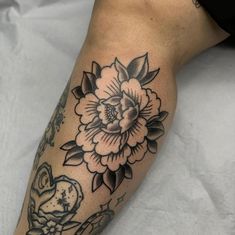 a woman's leg with a flower tattoo on it