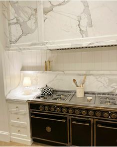 a stove top oven sitting inside of a kitchen next to a wall mounted oven and counter