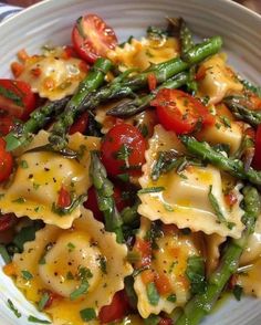 a white bowl filled with pasta and vegetables