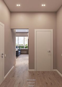 an empty room with white doors and hard wood flooring is seen in this image