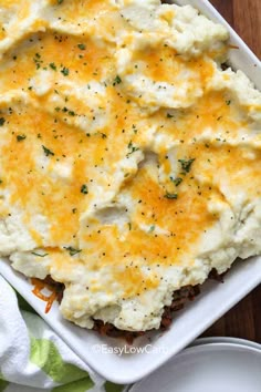 a casserole dish with mashed potatoes and cheese