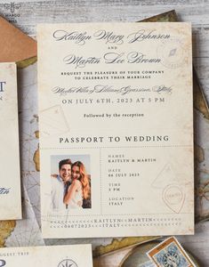 the wedding stationery is laid out on top of an old - fashioned map with stamps