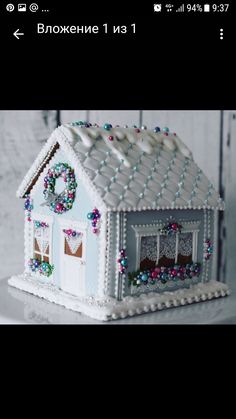 a white gingerbread house with decorations on it