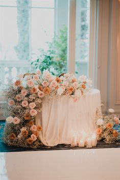 a table with flowers and candles on it