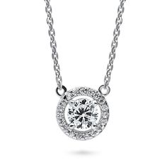 This halo pendant necklace exudes understated luxury, effortlessly elevating your style with beaming sparkle. Crafted with sterling silver, rhodium plated, stamped 925, nickel free. Main stone features premium quality 0.45 carat (5mm) round cubic zirconia in 4-prong setting. Accented with 0.1 ct. tw. CZ. Adjustable chain measures 16"-18" in length. Pendant measures 0.35" in diameter. Lobster claw clasp. Chain Ring Gold, Anniversary Necklace, Jewelry Education, Understated Luxury, Halo Pendant, Travel Jewelry Case, Bridesmaid Bracelet, Cz Pendant, Band Jewelry