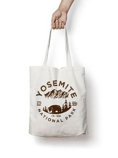 a person holding a tote bag that says yosemite national park