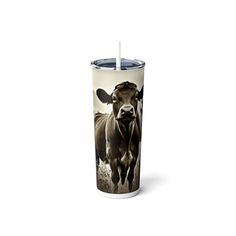 a cup with a cow on it and a straw sticking out of the top is shown