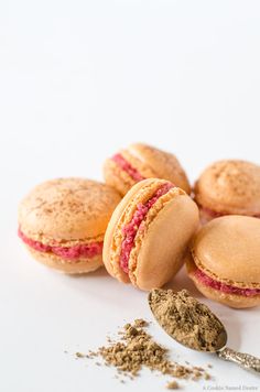 macaroons and powdered sugar on a white surface