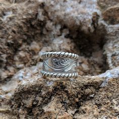 "Beautiful tapered sterling silver hand-engraved ring with silver \"rope\" edge, hand made with love in Eminence Missouri by western designer and engraver Ryan Liggett. Individual pieces may vary slightly from the pictured item. We make each piece by hand, one at a time, for every order. Because of this your final piece may vary slightly from the picture and engraving style may be adjusted slightly to fit your ring size or customizations. Please allow at least 2 to 4 weeks for shipment. Details: Cowgirl Ring, Western Ring, Boho Wedding Ring, Western Rings, Unique Mens Rings, Rustic Wedding Rings, Country Jewelry, Leather Craftsmen, Pattern Ring