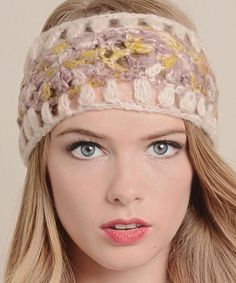 a woman with blonde hair wearing a headband made from yarn and crochet